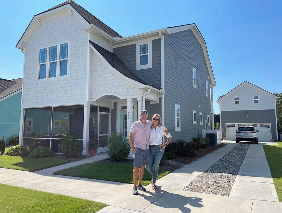 Main house street view with apartment over garage in background