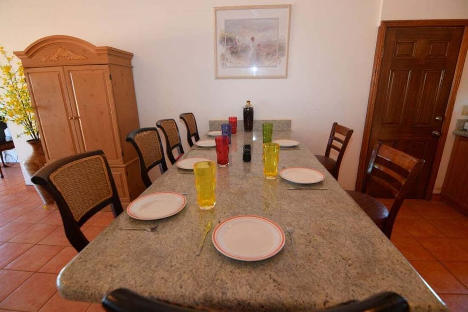 The upstairs kitchen in Condo B features a snack bar with nine bar stools and a casual dining area overlooking the living room and balcony.