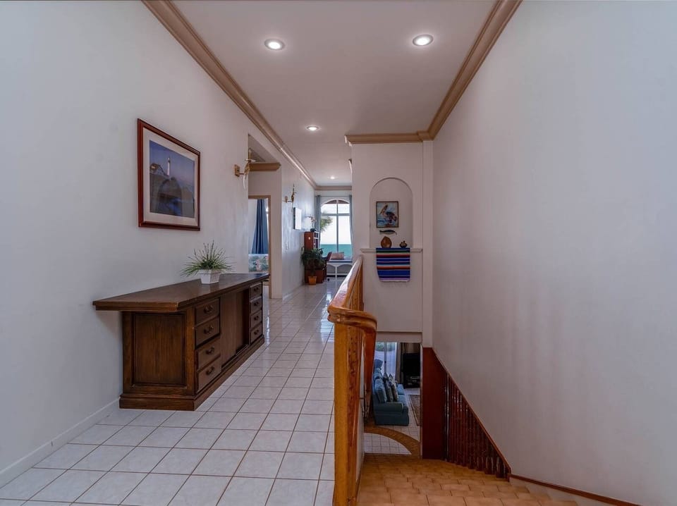 Wide hallway connecting living areas to bedrooms at this San Felipe BC MX beach house — easy flow for your group.