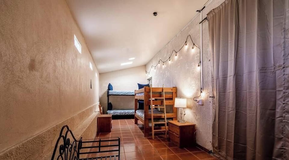 This separate guest room tucked away from the main living area features two bunk beds (four twin beds total),
