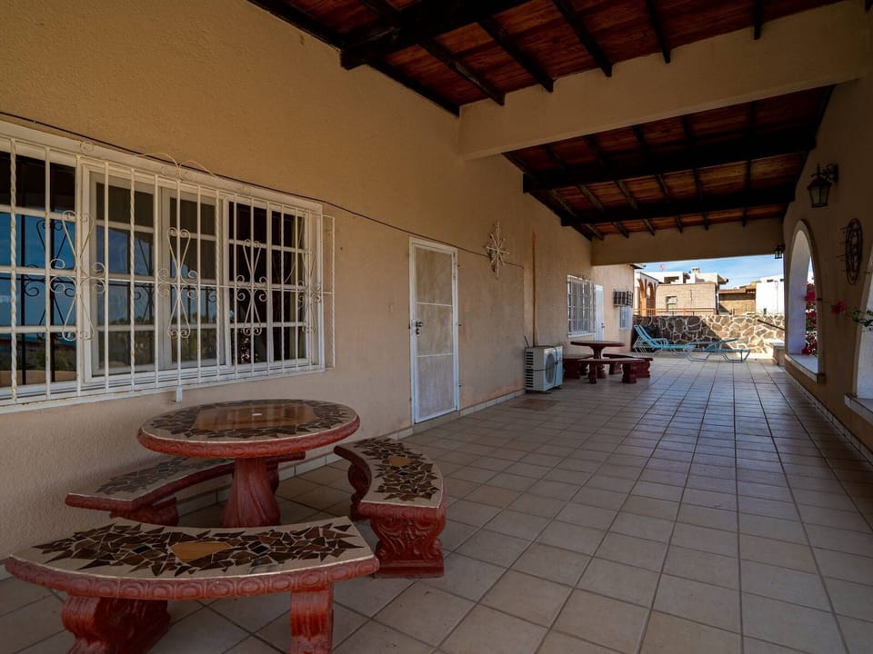The enormous backyard patio at Casa Vista del Mar features a BBQ, multiple seating areas, and plenty of space for groups to unwind — perfect for sunset cookouts after beach days.