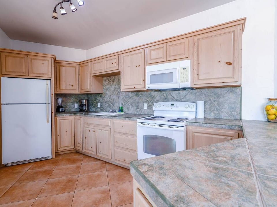 Save money on restaurants. This full kitchen at Casa Blanca vacation rental in San Felipe BC MX comes with stove, fridge, and counter space — cook your own meals and eat by the private pool.