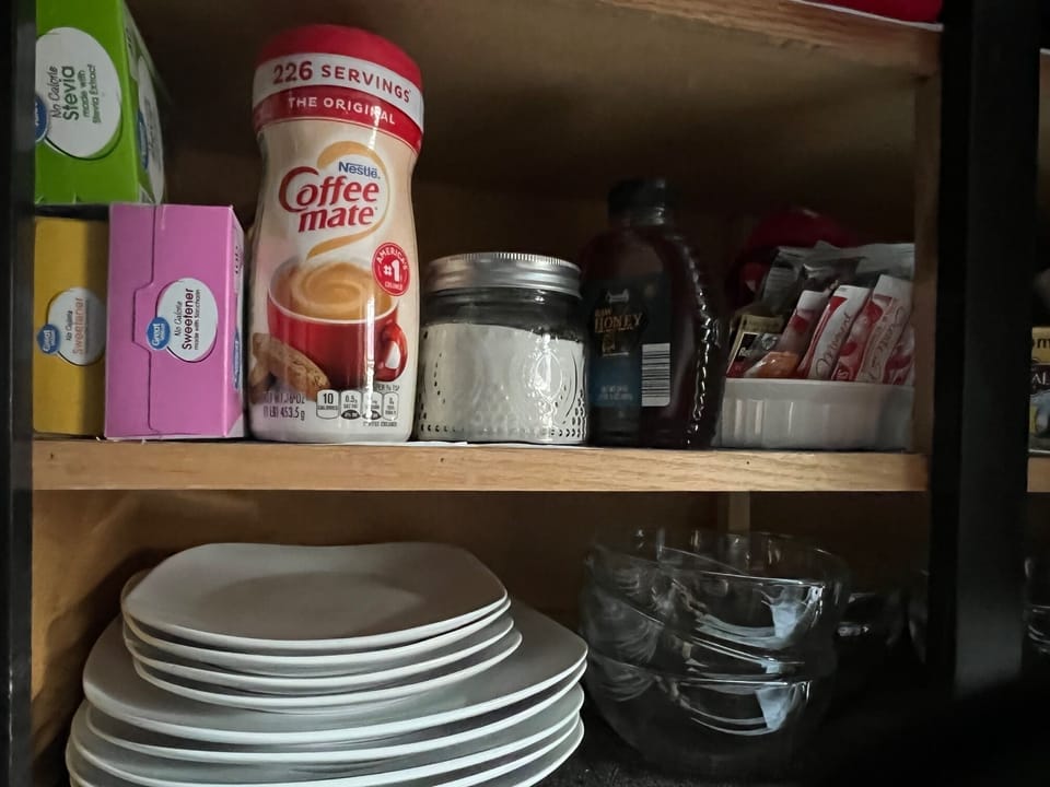 inside cabinet w/ coffee/tea supplies