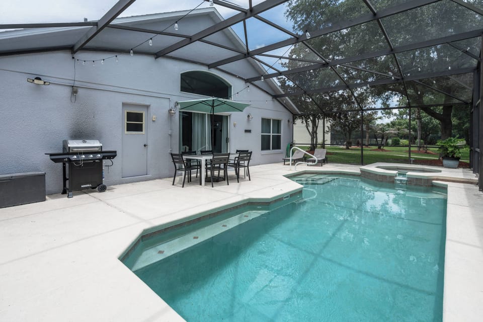 Enjoy your own private screened pool and spa, complete with lounge chairs, outdoor dining, and a shaded umbrella. A relaxing space to swim, soak up the Florida sunshine, or enjoy meals outdoors with family and friends.