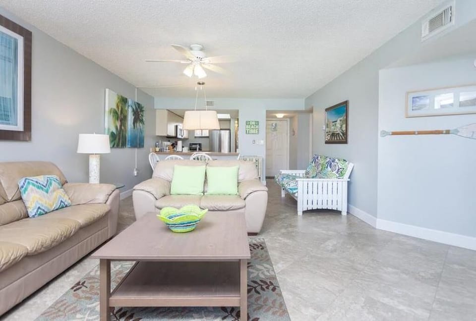 View of entrance and old kitchen / dining area from Living Room. Futon on right.