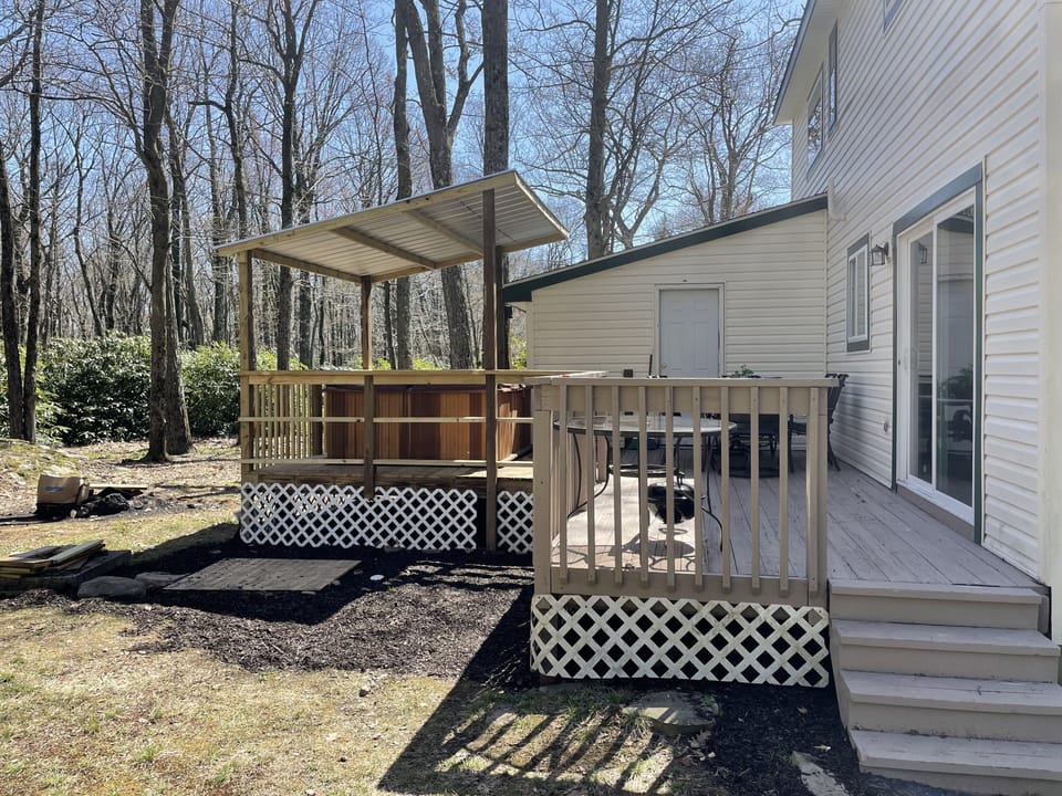 Backyard has a firepit, covered hottub and room to enjoy the outdoor space