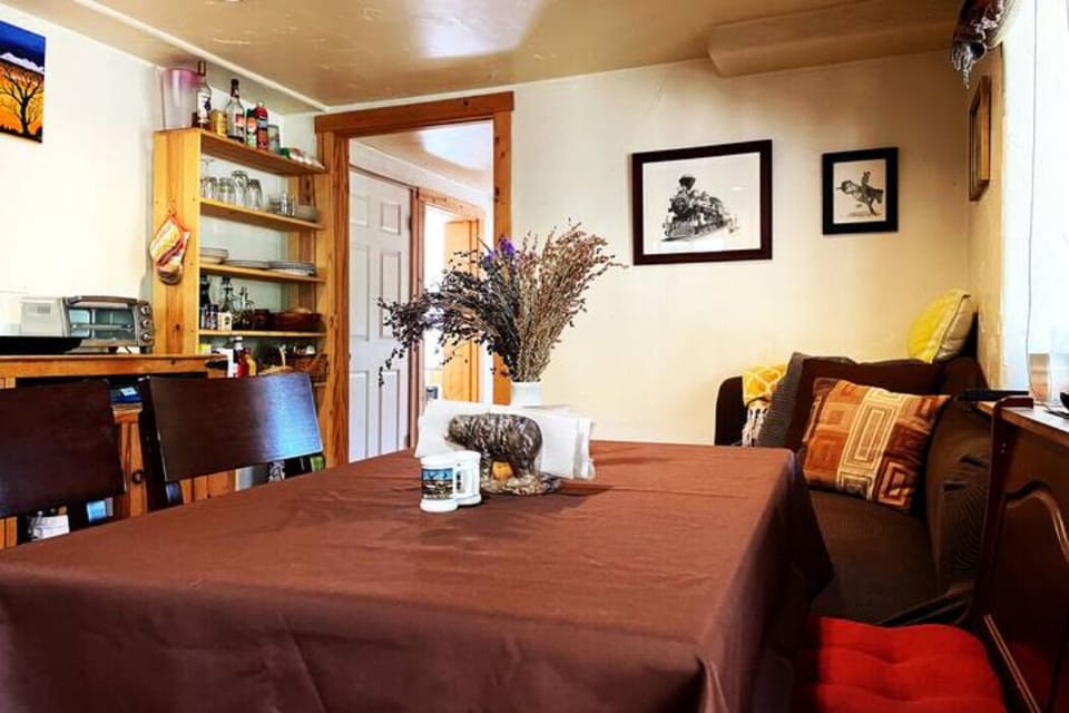 Downstairs living area, small tv, couch and dining table
