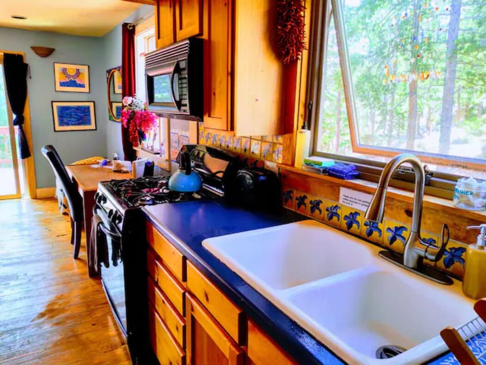 Main Kitchen upstairs with oven, gas stove, plenty of dishes and coffee maker