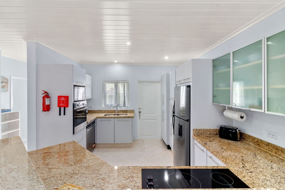 Large, fully equipped kitchen leading to utility area