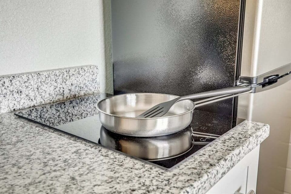 A clean induction cooktop ready for light cooking when you want to stay in.