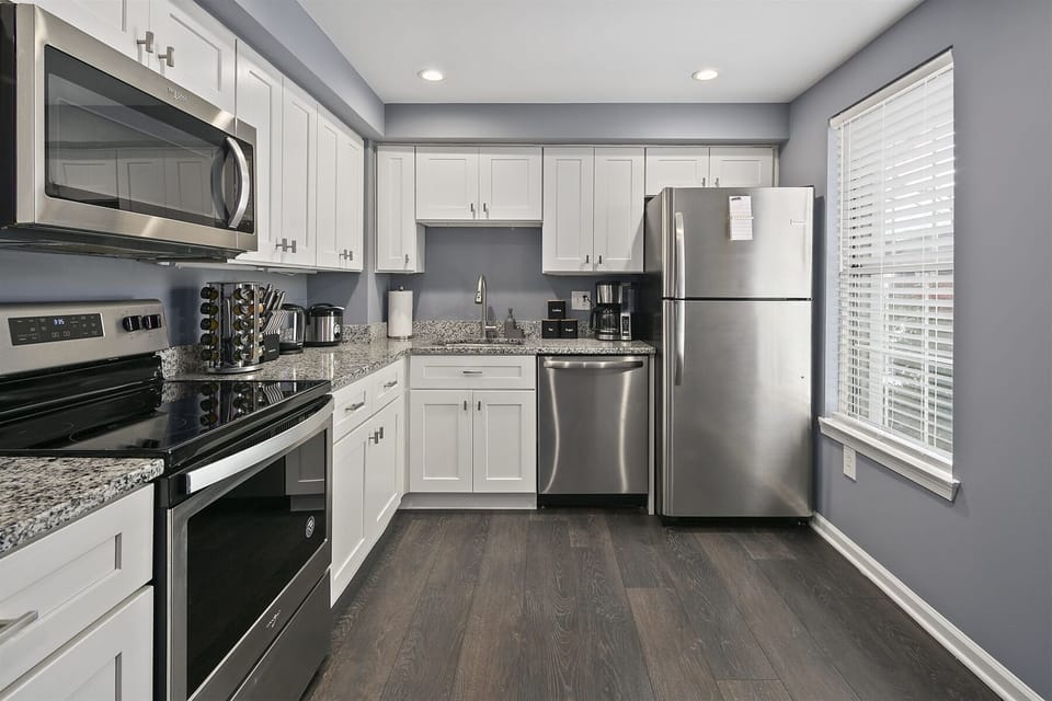 Kitchen cabinetry equipped with cooking/dining essentials
