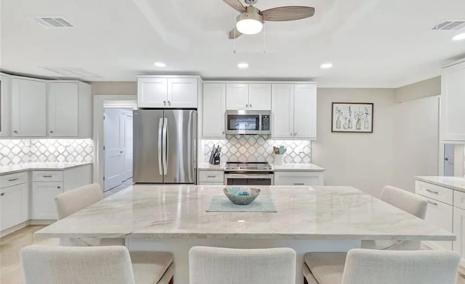 Fully stocked modern kitchen with breakfast bar for 4