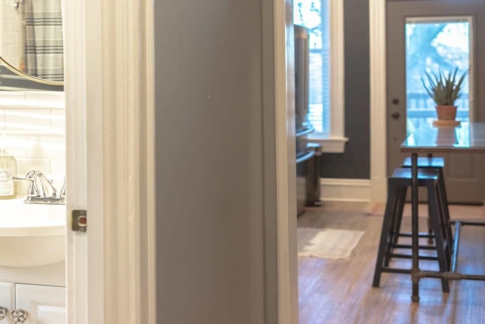 The bathroom is conveniently located between the bedrooms and the kitchen