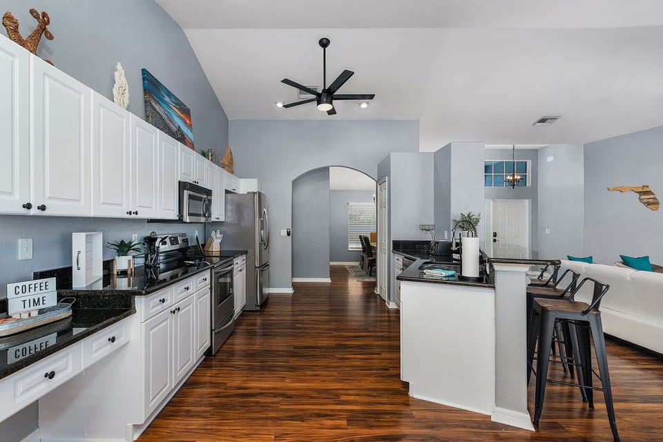 Fully stocked kitchen is accessible to the dining room and nook at opposite end.