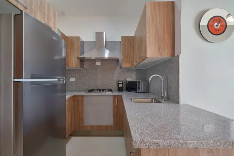 Open fully equipped kitchen with Breakfast bar and all the utensils needed.
