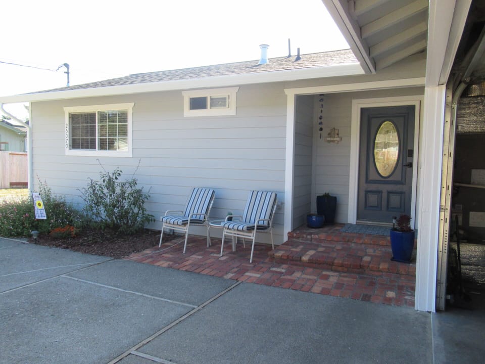 The front porch has seating for viewing and is near the garage game room.