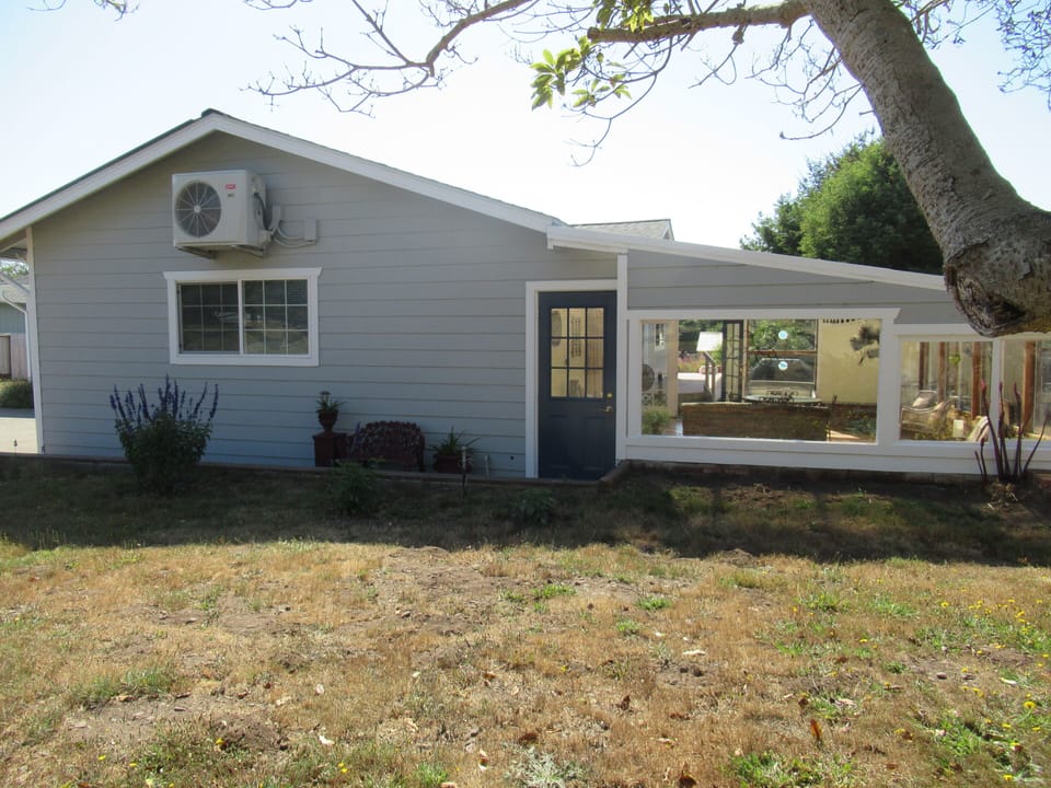 Side of house showing the enclosed sunroom. 