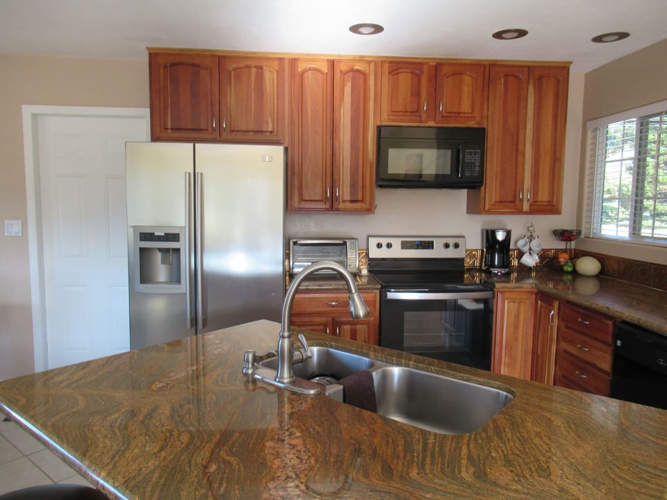 Kitchen counter bar area with seating for 3 on stools. 