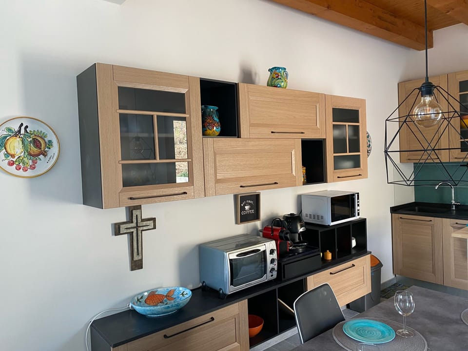Kitchen with microwave, toaster, and Nespresso coffee maker.  