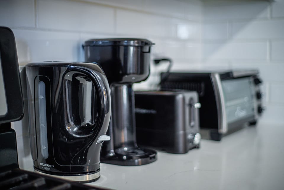 Kettle, coffee maker with assortment of coffee & tea, toaster, & toaster oven