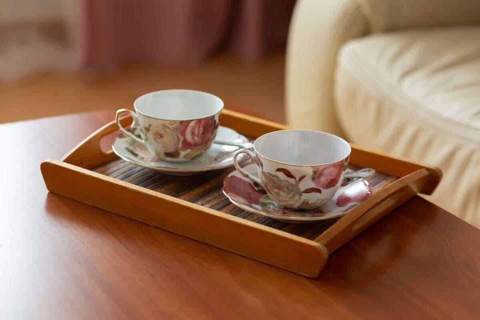 A cozy living room moment captured with a wooden tray holding teacups, adding warmth and personality to the space.