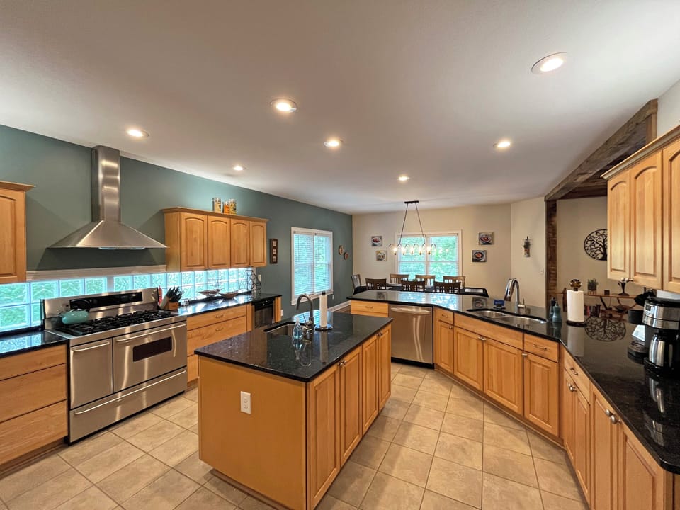 The Kitchen is spacious with large island and 2 sinks.  Gas cooktop, double ovens, and lots of counter space, make it easy for families to share in the cooking experience.