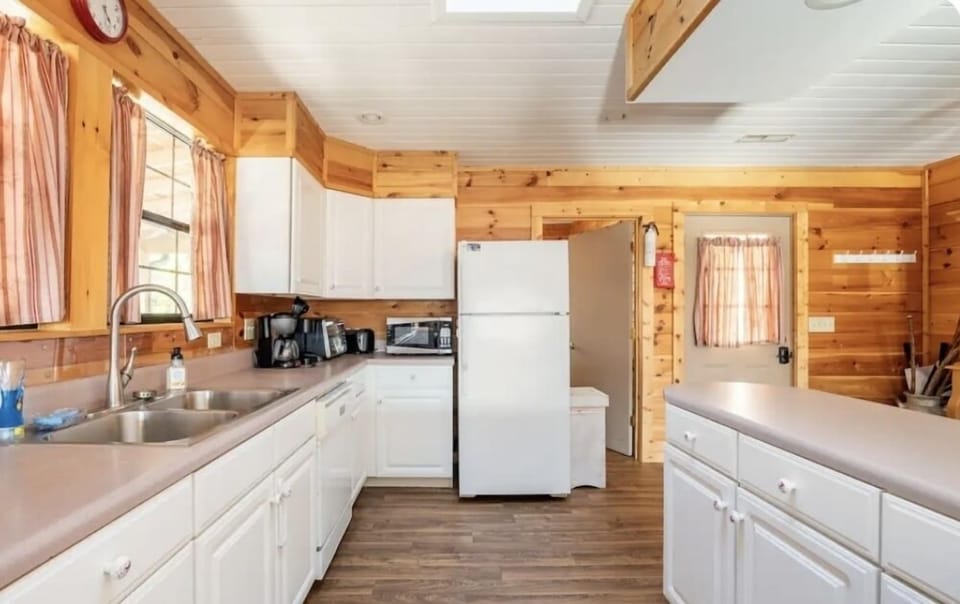 Kitchen with stove, oven, dishwasher, toaster oven, refrigerator and ice maker. 
