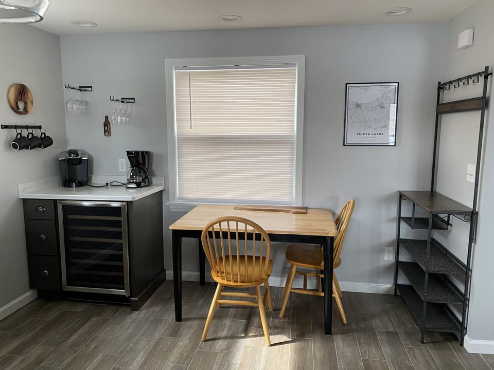 Kitchen has an extra table, a place for shoes and purses, and charcuterie board