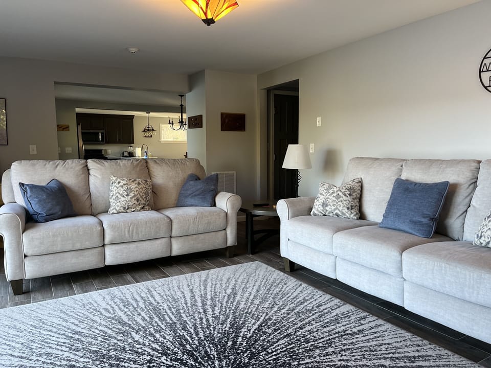 Living room has two couches with 6 seats, four have electric reclining.