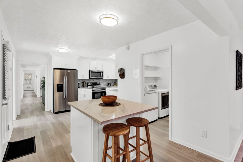 Open full kitchen w/stainless steel appliances, island, garage access -MainLevel