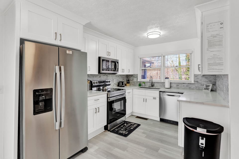 Open full kitchen w/stainless steel appliances, island, garage access -MainLevel