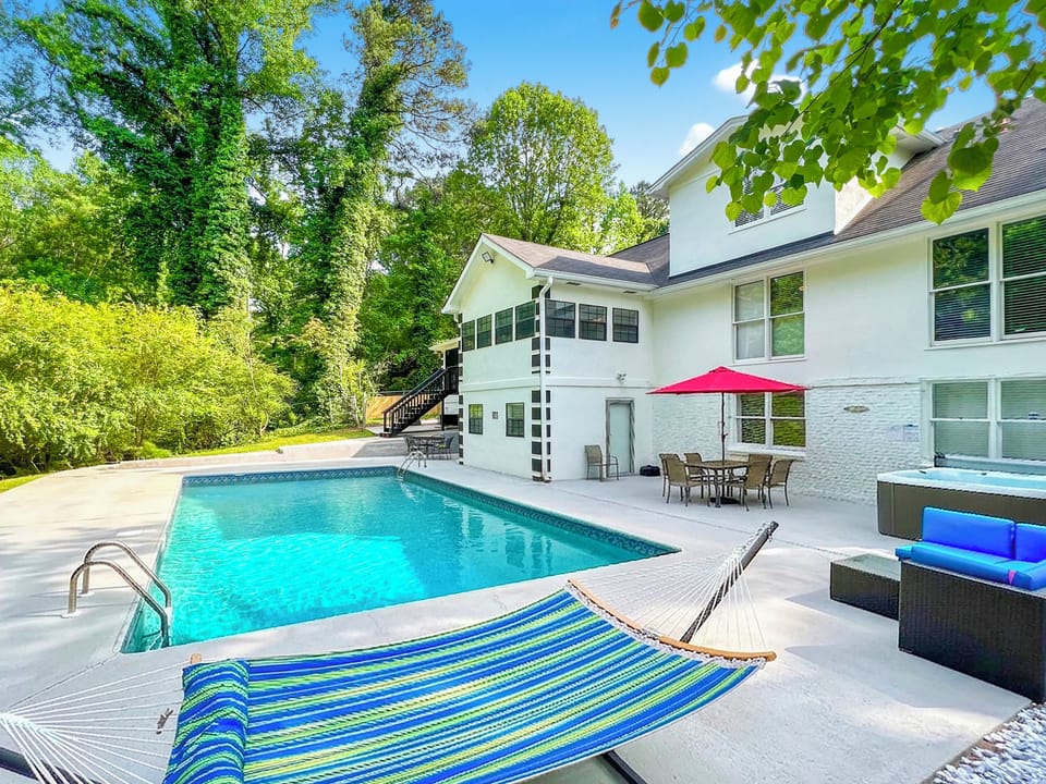 Backyard deck: seasonal pool,year-round hot tub,seating,dining,hammock,cornhole