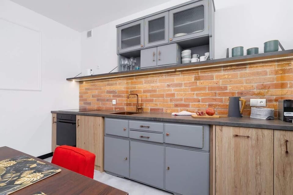 The kitchen's sleek design includes all necessary cookware and utensils. 