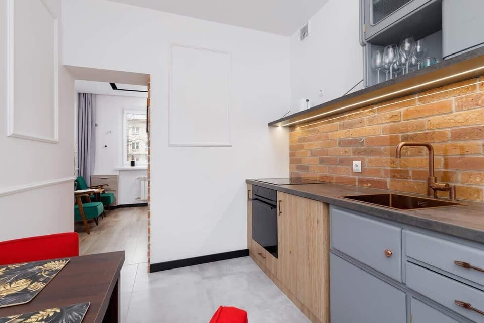 The kitchen's contemporary decor complements the apartment's style.