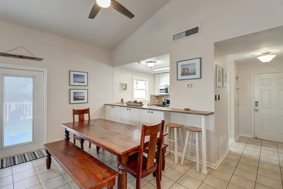 Your open kitchen and dining area invites morning coffee at the breakfast bar or family meals around the warm wooden table.