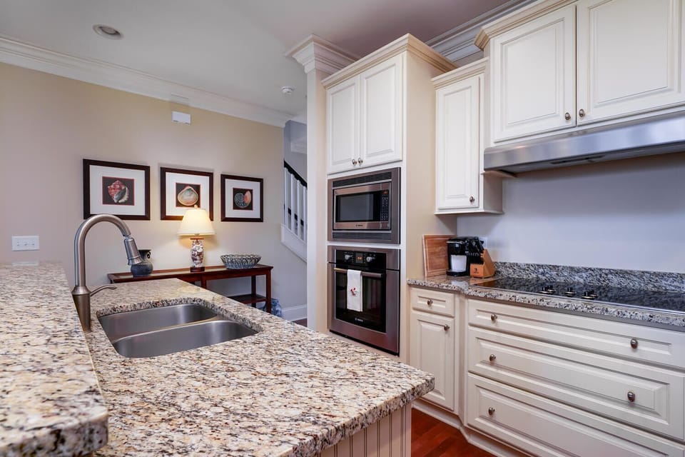 The updated kitchen has stainless steel Bosch appliances, granite countertops.
