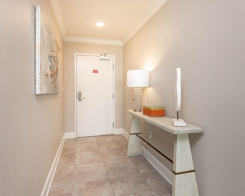 Step into a welcoming entryway that sets the tone for your beach retreat, with soothing decor and warm lighting