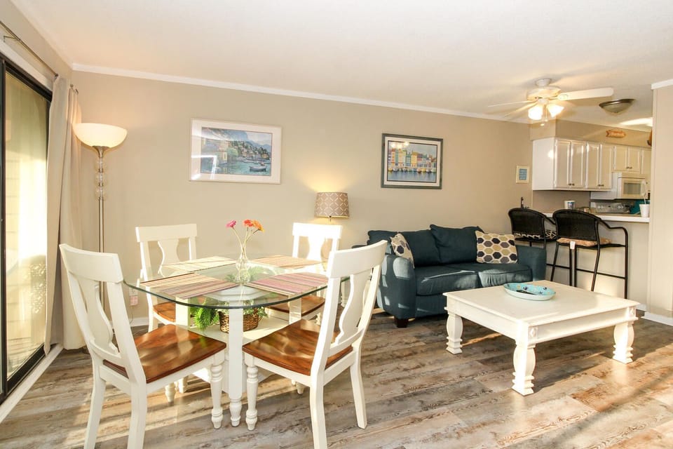 Dining room table with 4 seats and 2 more at the serving bar. 