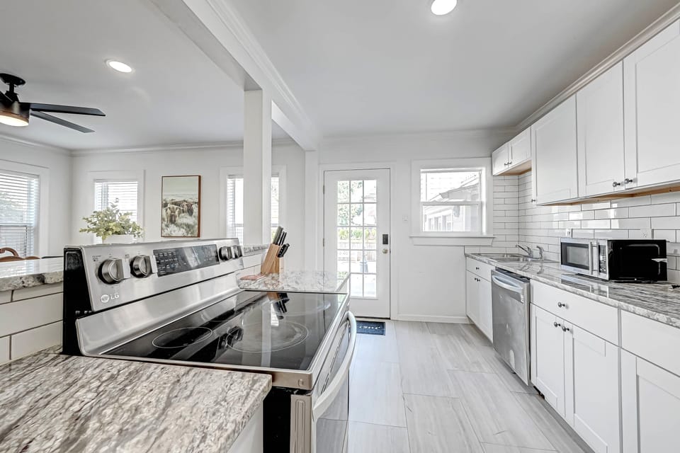 Large kitchen. New stainless appliances Spring 2022. Back entrance shown here.