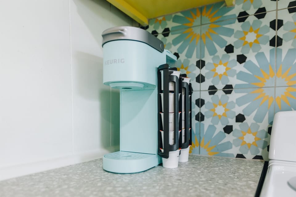 K-Cup Machine with starter pack of pods provided along with creamer and sugar