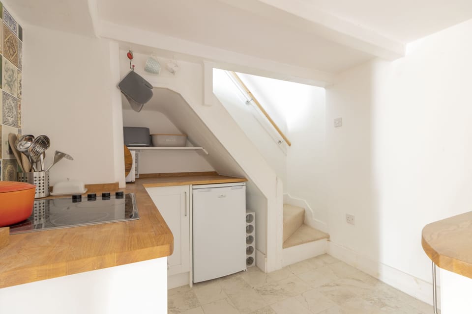 Kitchen and stairs leading up to the first floor
