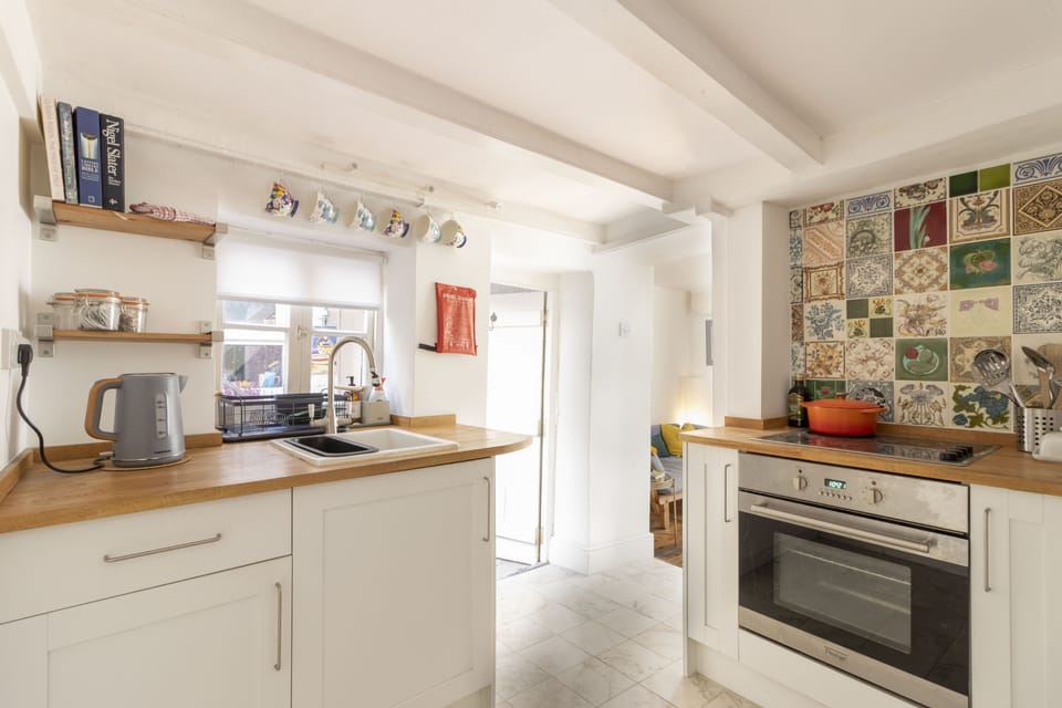 The colourful cottage kitchen leads directly into the lounge and dining area with a door out to the rear terraced garden