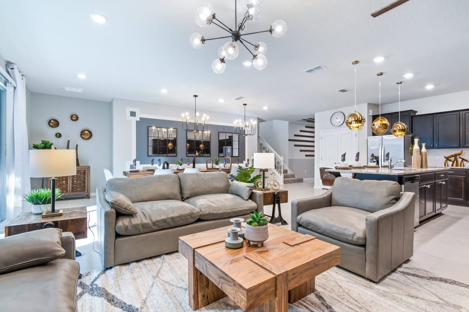 Relax and unwind in our modern and spacious living room. This area features comfortable seating, stylish decor and an open-plan layout that seamlessly connects to the dining and kitchen areas
