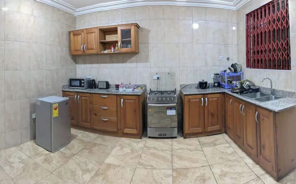 Kitchen with fridge, microwave, cooker, oven, and washing machine