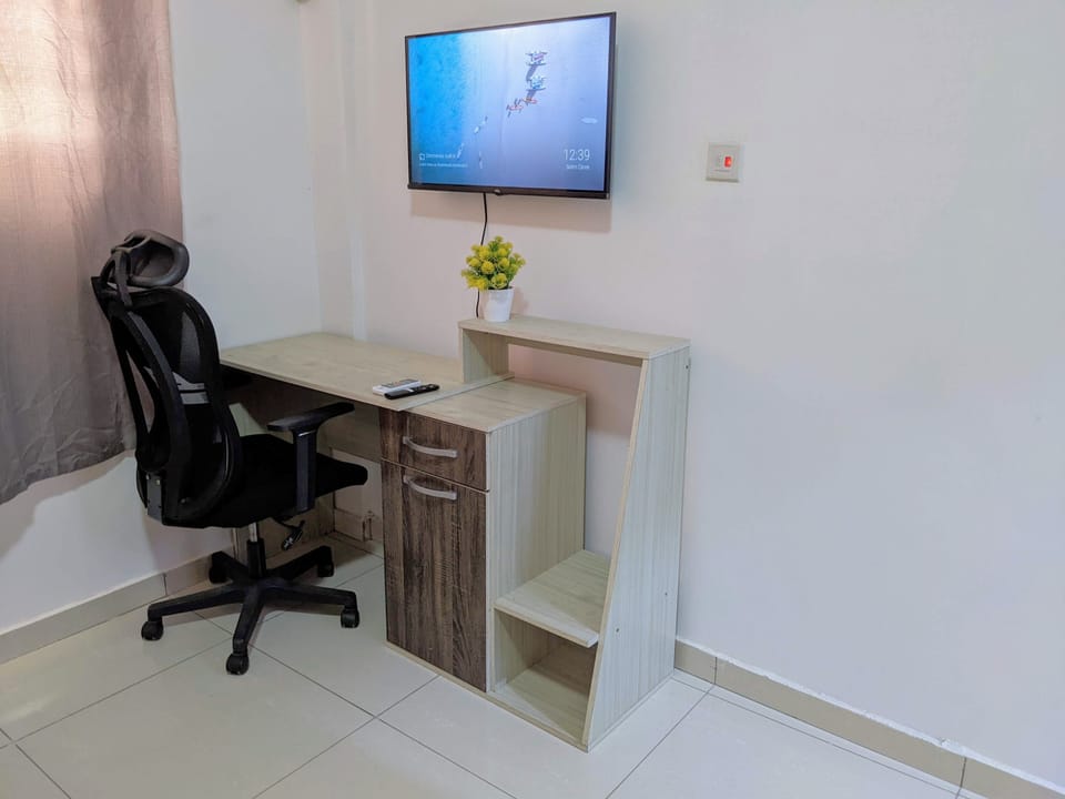 Work desk and chair and TV in bedroom