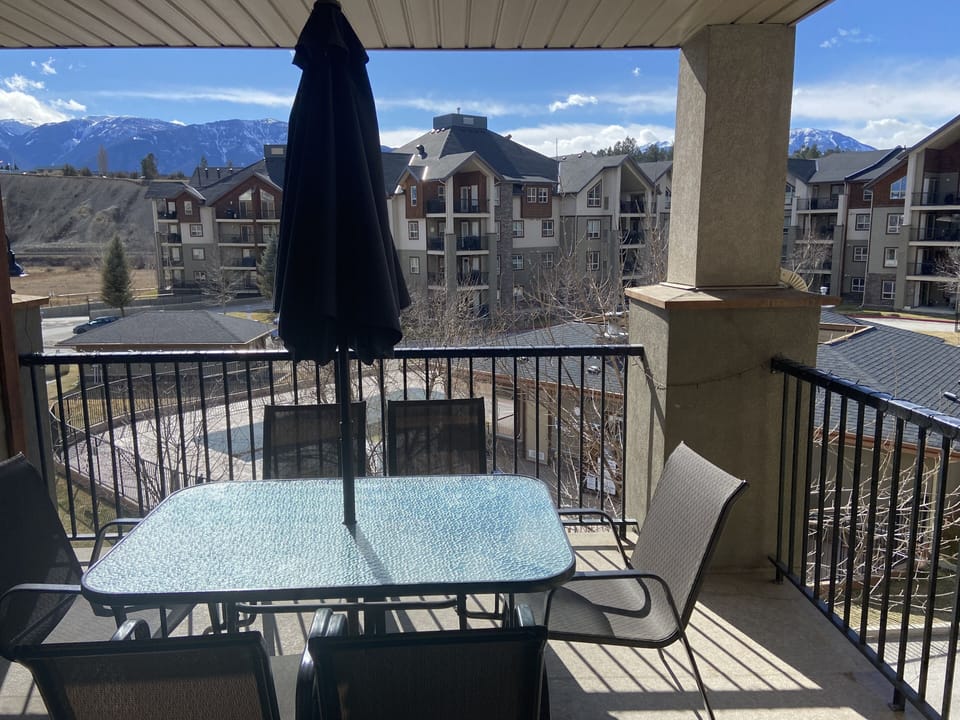 Patio has mountain and lake views. Overlooks the hot tub and swimming pool. 