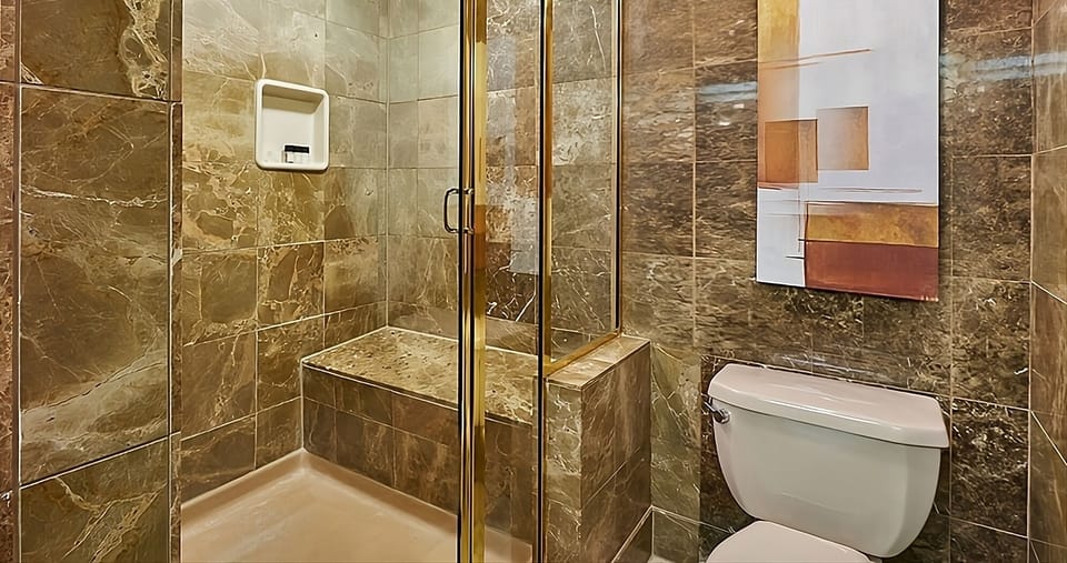 Rinse off in a sleek shower with spa-like tilework.