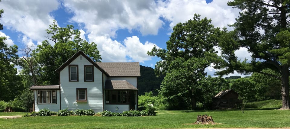 The Farmhouse.  You'll enter through the porch on the left side of the house.