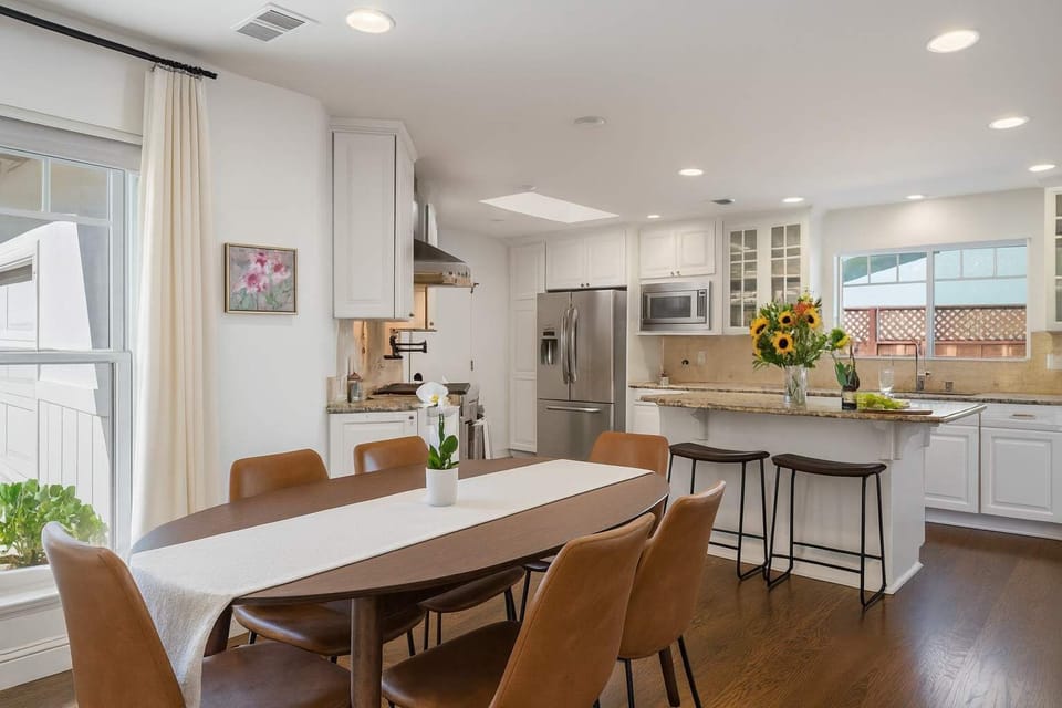 Beautifully designed dining area with a stylish kitchen, sunlit windows, and everything you need for a relaxed and enjoyable stay.