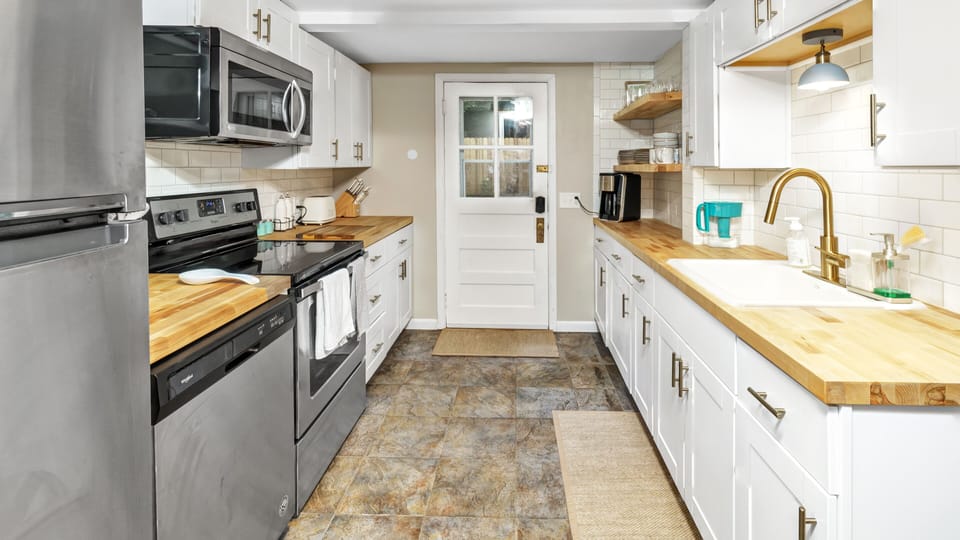 Modern farmhouse galley kitchen looking towards the dining area
